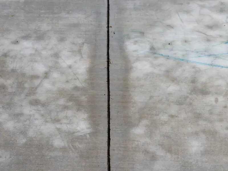 Light concrete slab with a long crack following a joint