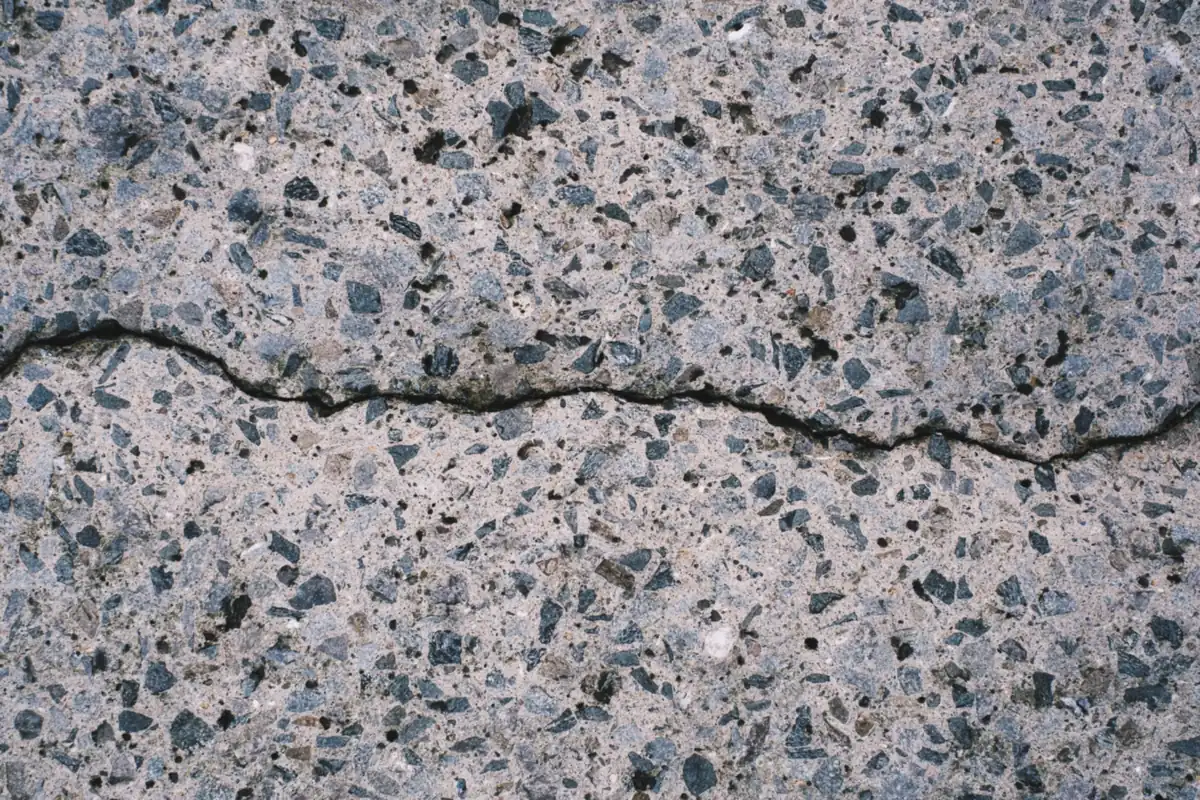 Long crack running through weathered exposed-aggregate concrete